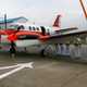 A Philippine Navy personnel paves the way for a Japanese Defense Ministry Beechcraft TC90 training aircraft to park Monday, March 27, 2017 at Naval Air Group in Sangley Point, Cavite province south of Manila, Philippines.(AP Photo/Bullit Marquez)